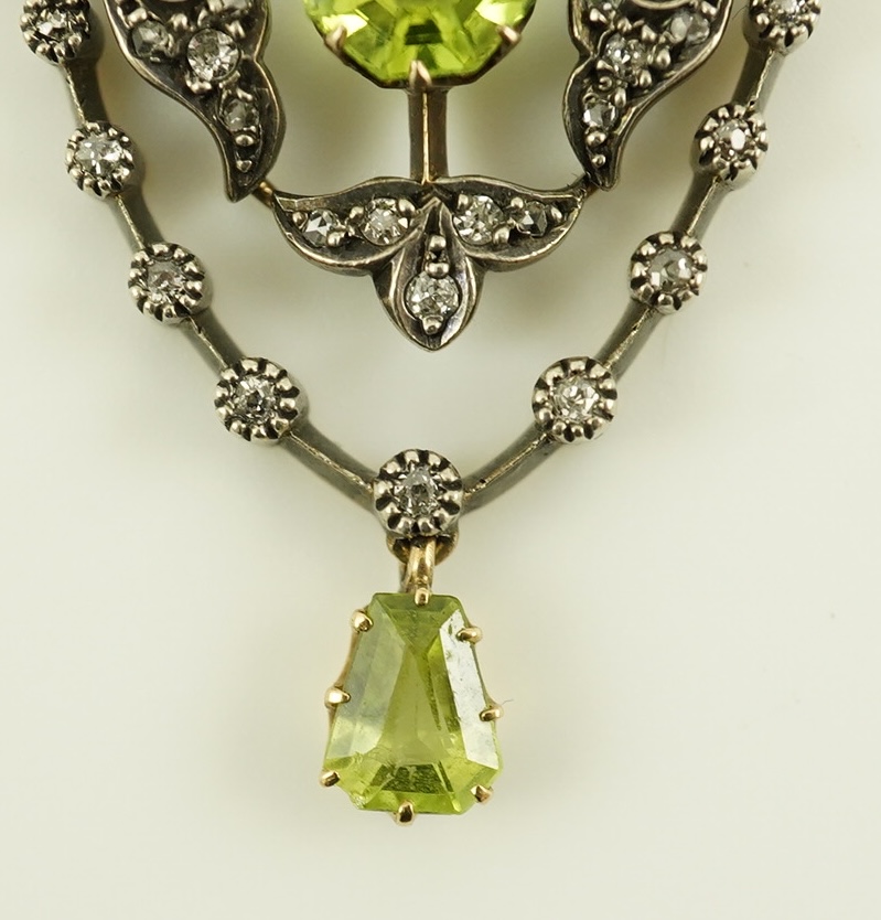 A Victorian gold and silver, peridot and diamond cluster set articulated drop pendant